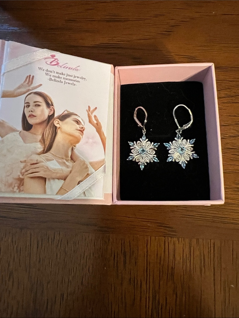 Sterling Silver Snowflake Drop Earrings with Light Blue Accents